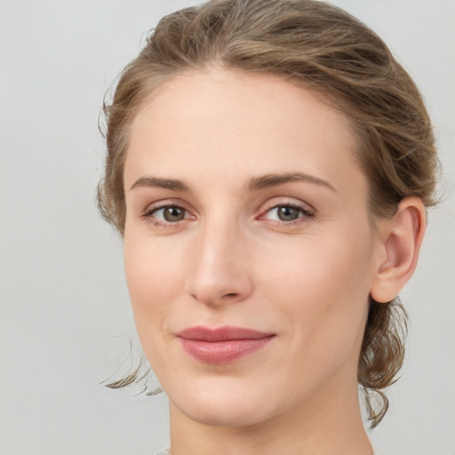 Joyful white young-adult female with medium  brown hair and green eyes