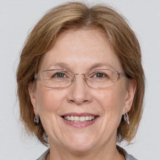 Joyful white middle-aged female with medium  brown hair and grey eyes