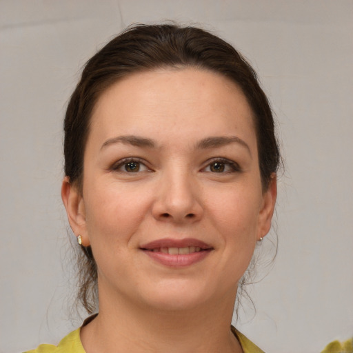 Joyful white young-adult female with medium  brown hair and brown eyes