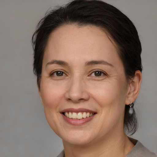 Joyful white adult female with medium  brown hair and brown eyes