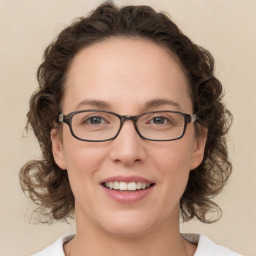 Joyful white young-adult female with medium  brown hair and green eyes