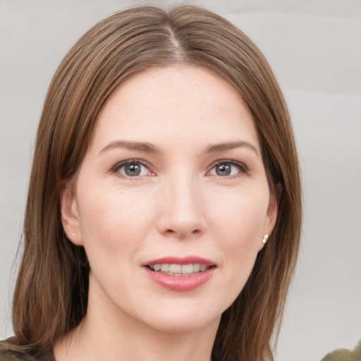 Joyful white young-adult female with medium  brown hair and grey eyes