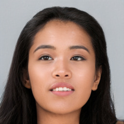 Joyful asian young-adult female with long  brown hair and brown eyes