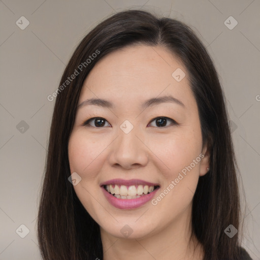 Joyful asian young-adult female with long  brown hair and brown eyes