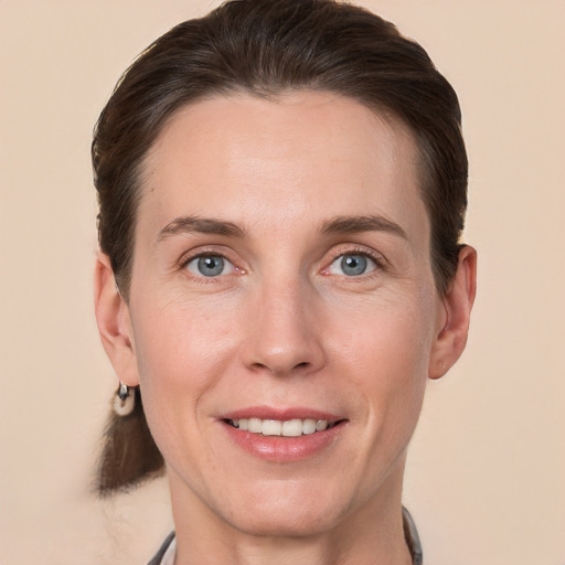 Joyful white adult female with short  brown hair and grey eyes