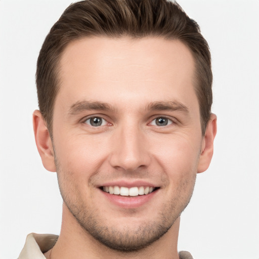 Joyful white young-adult male with short  brown hair and grey eyes