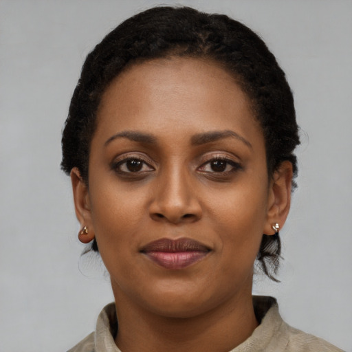 Joyful black young-adult female with short  black hair and brown eyes
