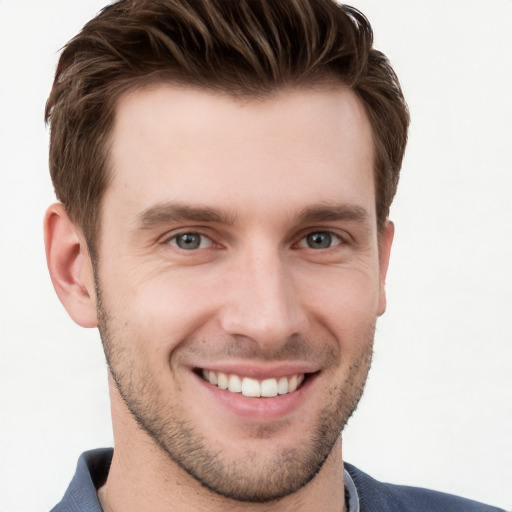 Joyful white young-adult male with short  brown hair and grey eyes