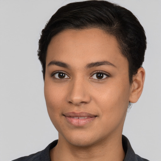 Joyful latino young-adult female with short  black hair and brown eyes