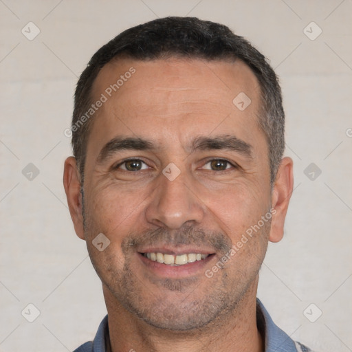 Joyful white adult male with short  black hair and brown eyes