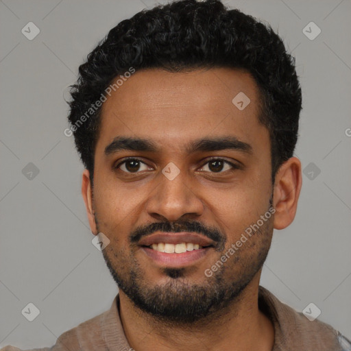 Joyful black young-adult male with short  black hair and brown eyes