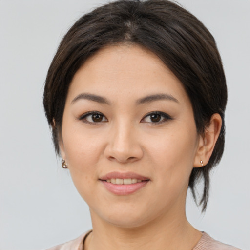 Joyful asian young-adult female with medium  brown hair and brown eyes