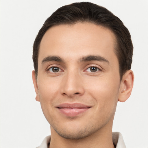 Joyful white young-adult male with short  brown hair and brown eyes