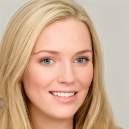 Joyful white young-adult female with long  brown hair and blue eyes