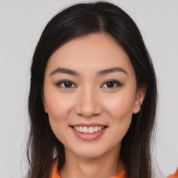 Joyful asian young-adult female with long  brown hair and brown eyes