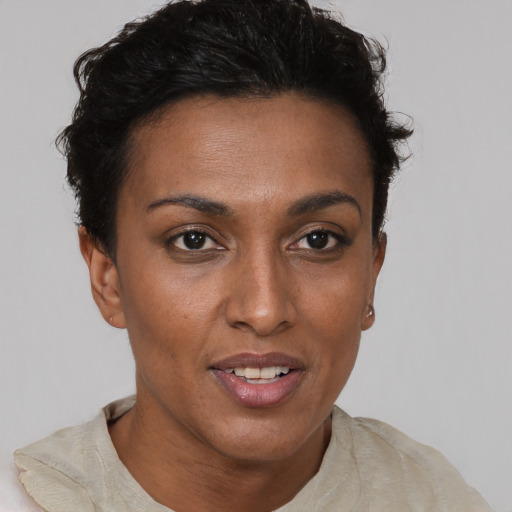 Joyful black young-adult female with short  brown hair and brown eyes