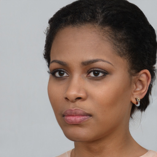 Neutral black young-adult female with medium  brown hair and brown eyes