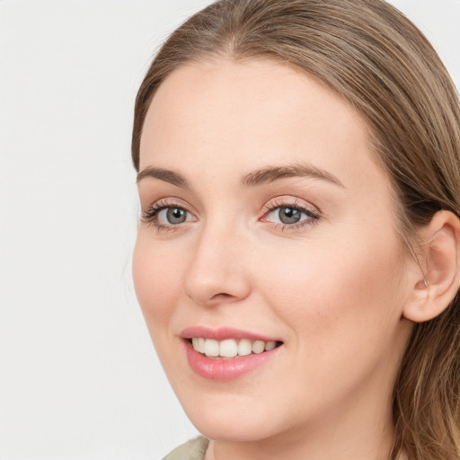 Joyful white young-adult female with long  brown hair and green eyes