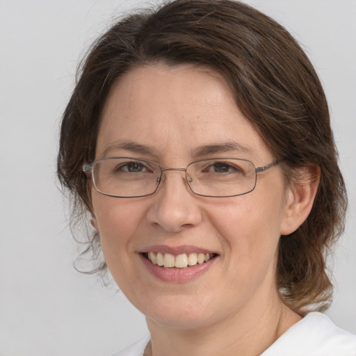 Joyful white adult female with medium  brown hair and brown eyes