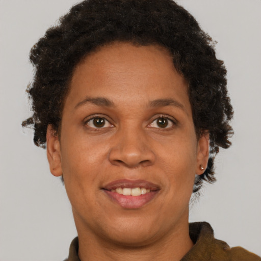 Joyful black adult female with short  brown hair and brown eyes