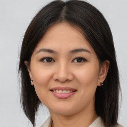 Joyful latino young-adult female with medium  brown hair and brown eyes