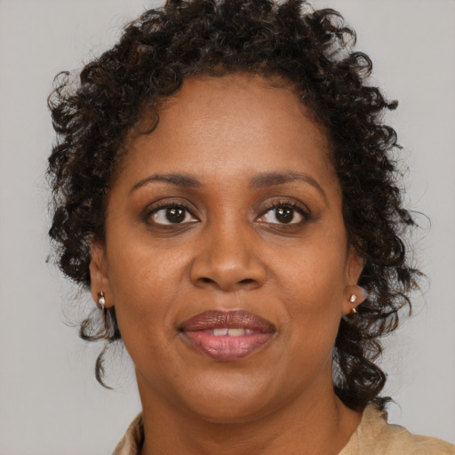 Joyful black young-adult female with medium  brown hair and brown eyes