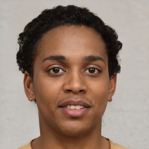 Joyful black young-adult female with short  brown hair and brown eyes