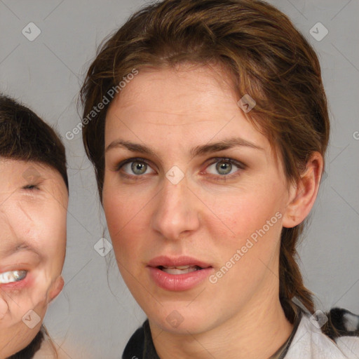 Joyful white adult female with medium  brown hair and brown eyes