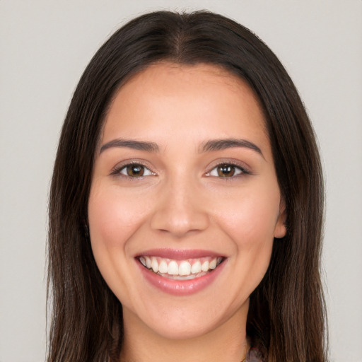 Joyful white young-adult female with long  brown hair and brown eyes