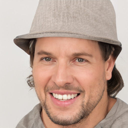 Joyful white adult male with short  brown hair and grey eyes