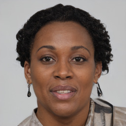 Joyful black adult female with short  brown hair and brown eyes