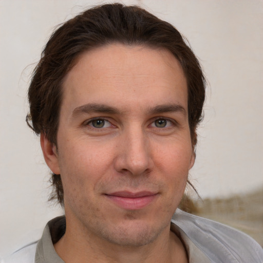 Joyful white adult male with short  brown hair and brown eyes