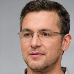 Joyful white adult male with short  brown hair and brown eyes