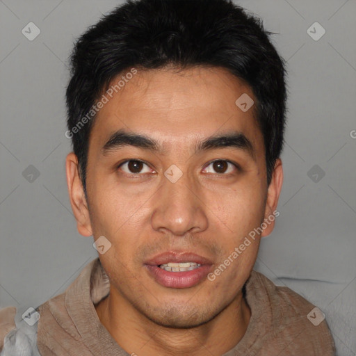 Joyful asian young-adult male with short  black hair and brown eyes