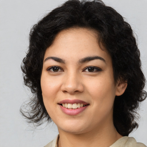 Joyful latino young-adult female with medium  brown hair and brown eyes