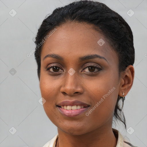 Joyful black young-adult female with short  brown hair and brown eyes