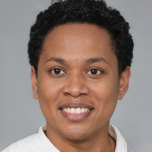Joyful black adult female with short  brown hair and brown eyes