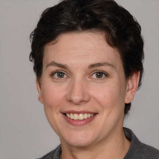 Joyful white adult female with short  brown hair and grey eyes