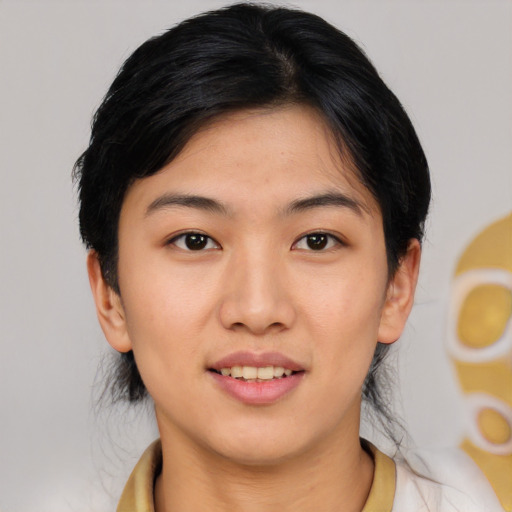 Joyful asian young-adult female with medium  black hair and brown eyes