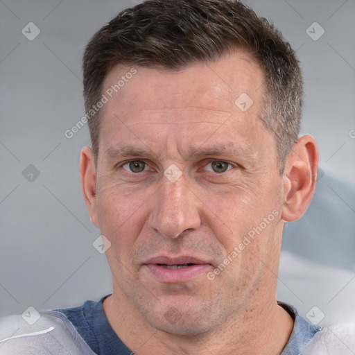 Joyful white adult male with short  brown hair and grey eyes