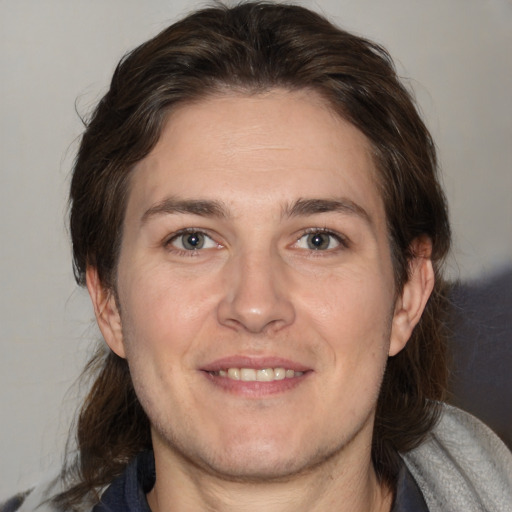 Joyful white adult male with medium  brown hair and brown eyes