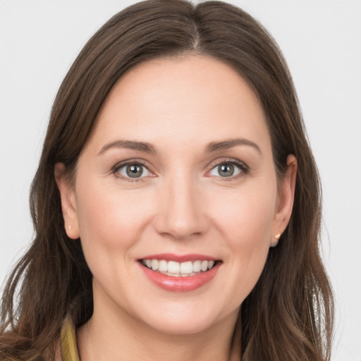 Joyful white young-adult female with long  brown hair and grey eyes