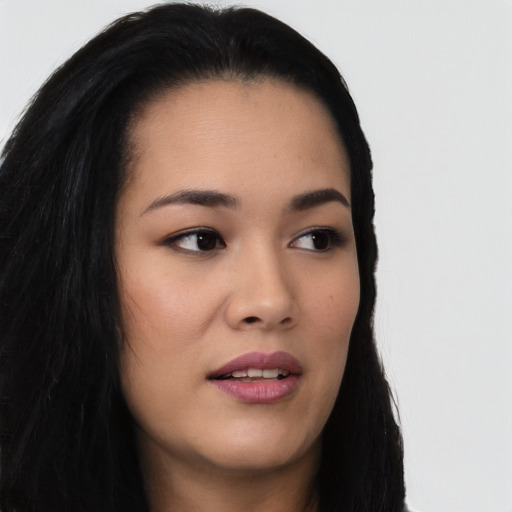 Joyful asian young-adult female with long  brown hair and brown eyes