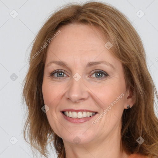 Joyful white adult female with medium  brown hair and grey eyes