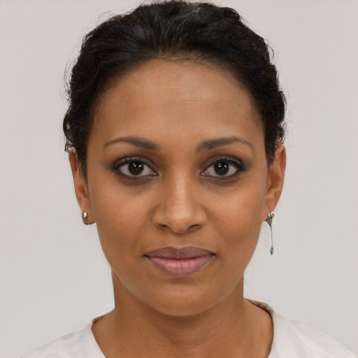 Joyful black young-adult female with short  brown hair and brown eyes
