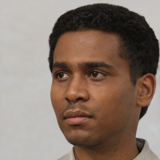 Neutral black young-adult male with short  black hair and brown eyes