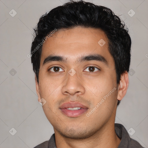 Joyful asian young-adult male with short  black hair and brown eyes