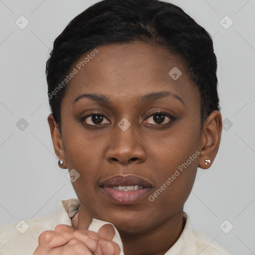 Joyful black young-adult female with short  brown hair and brown eyes