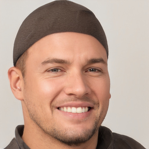 Joyful white young-adult male with short  brown hair and brown eyes