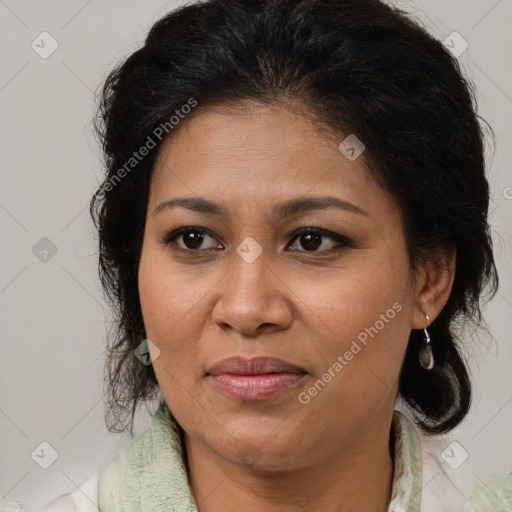 Joyful latino adult female with medium  brown hair and brown eyes